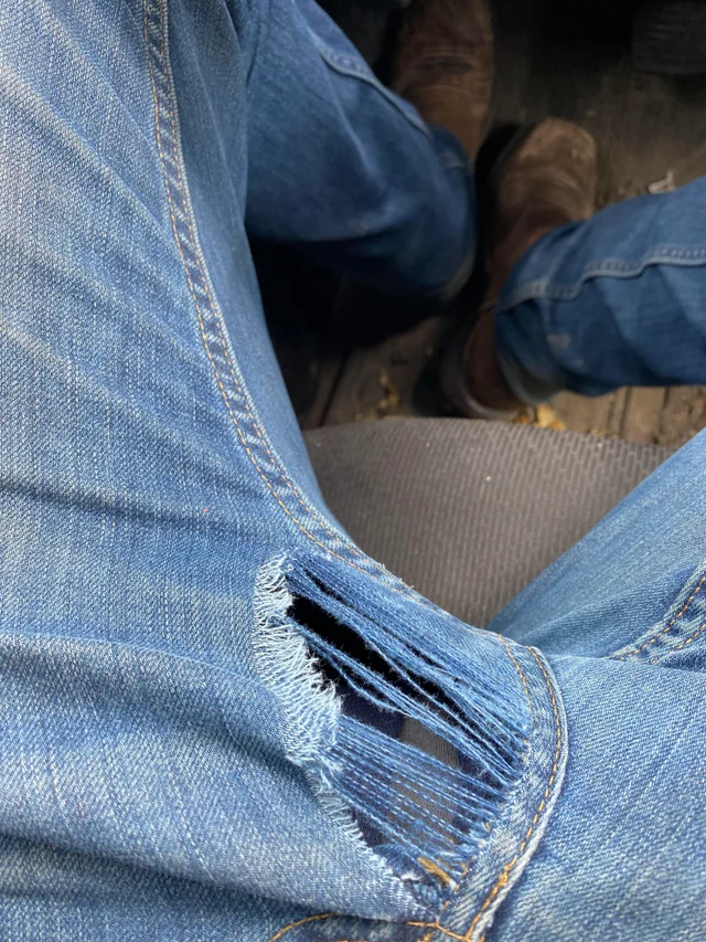 Threadbare jeans at crotch